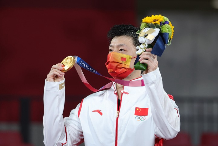 2021年7月30日，马龙在颁奖典礼上展示金牌。新华社记者 王东震 摄